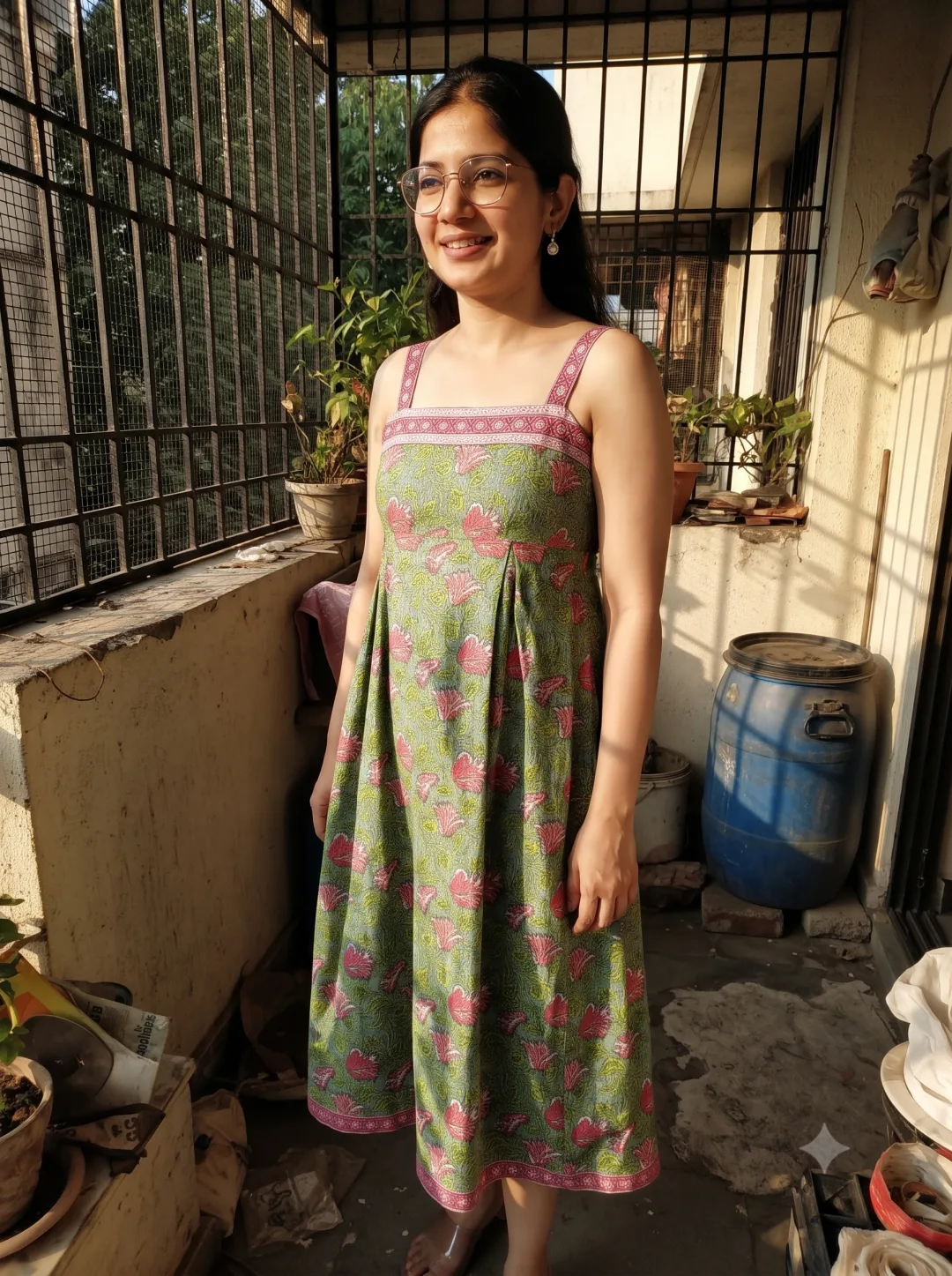 Riya wearing the green floral fit and flare midi