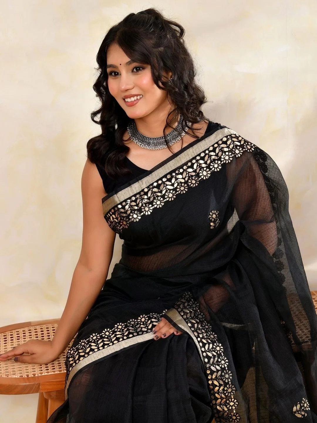 Black Kota Doria gota patti saree — seated side view