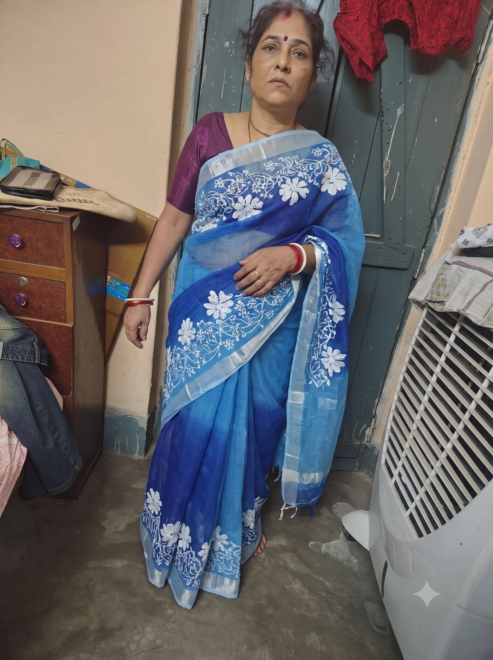 Customer wearing blue floral embroidered saree