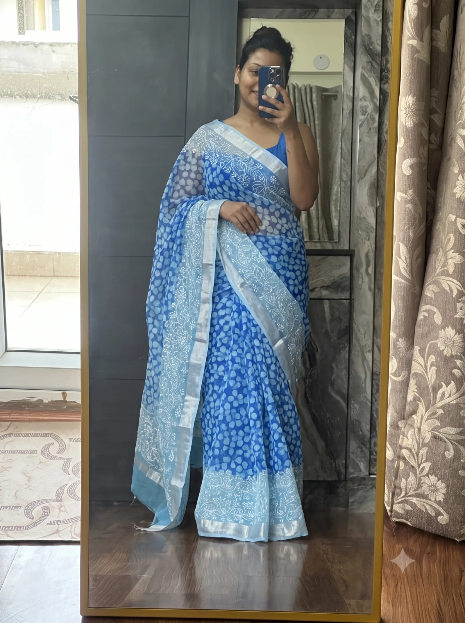 Customer wearing blue floral embroidered saree