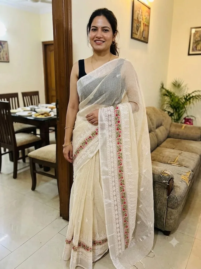 Customer wearing cream Kota Doria floral embroidered saree at a family lunch