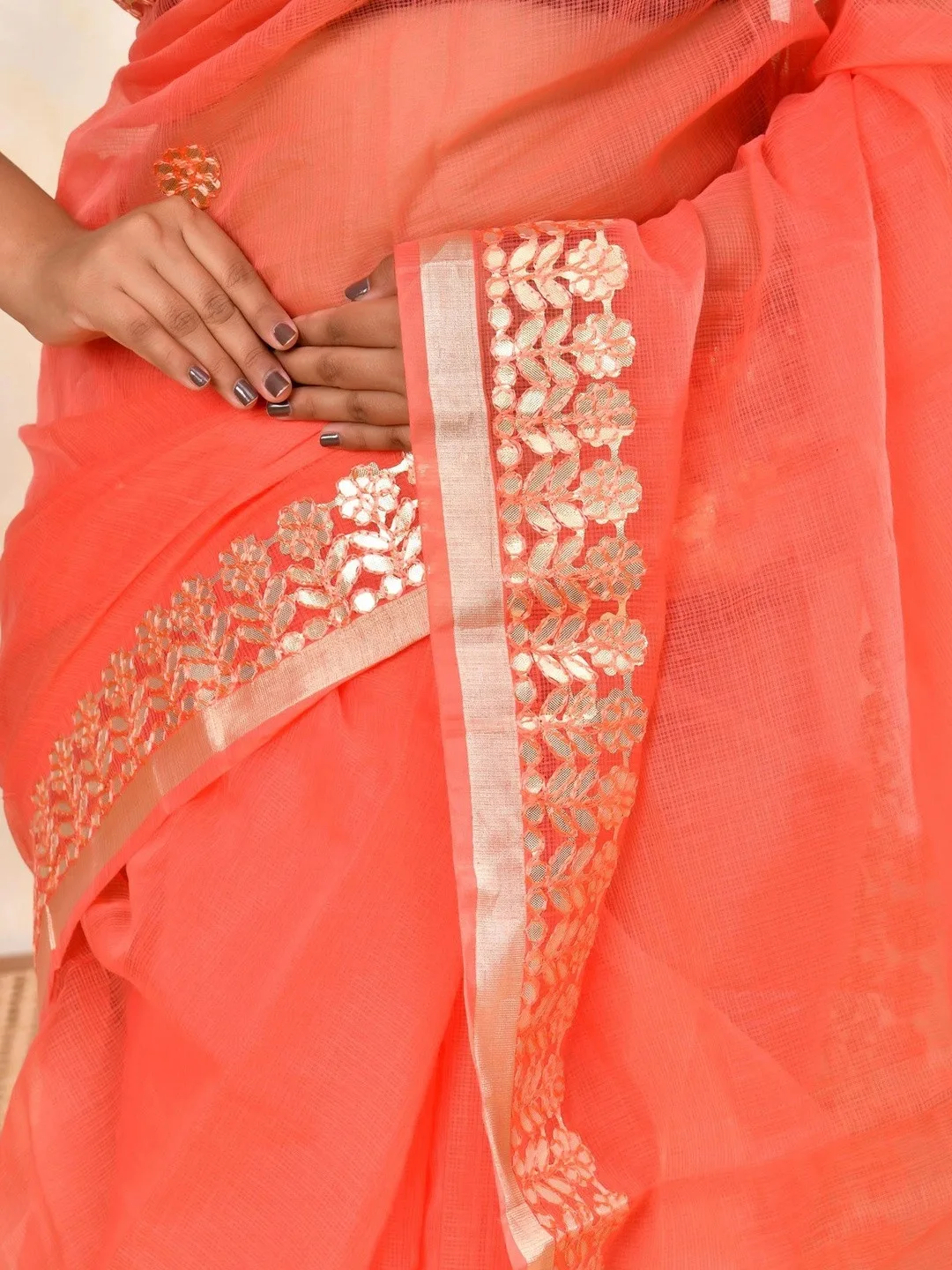 Zari and embroidered border on peach Kota Doria — detail