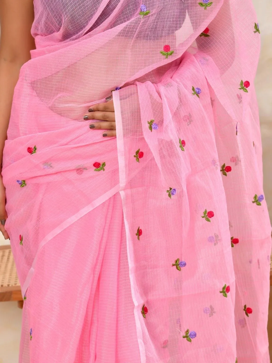Scattered floral embroidery on pink Kota Doria — detail