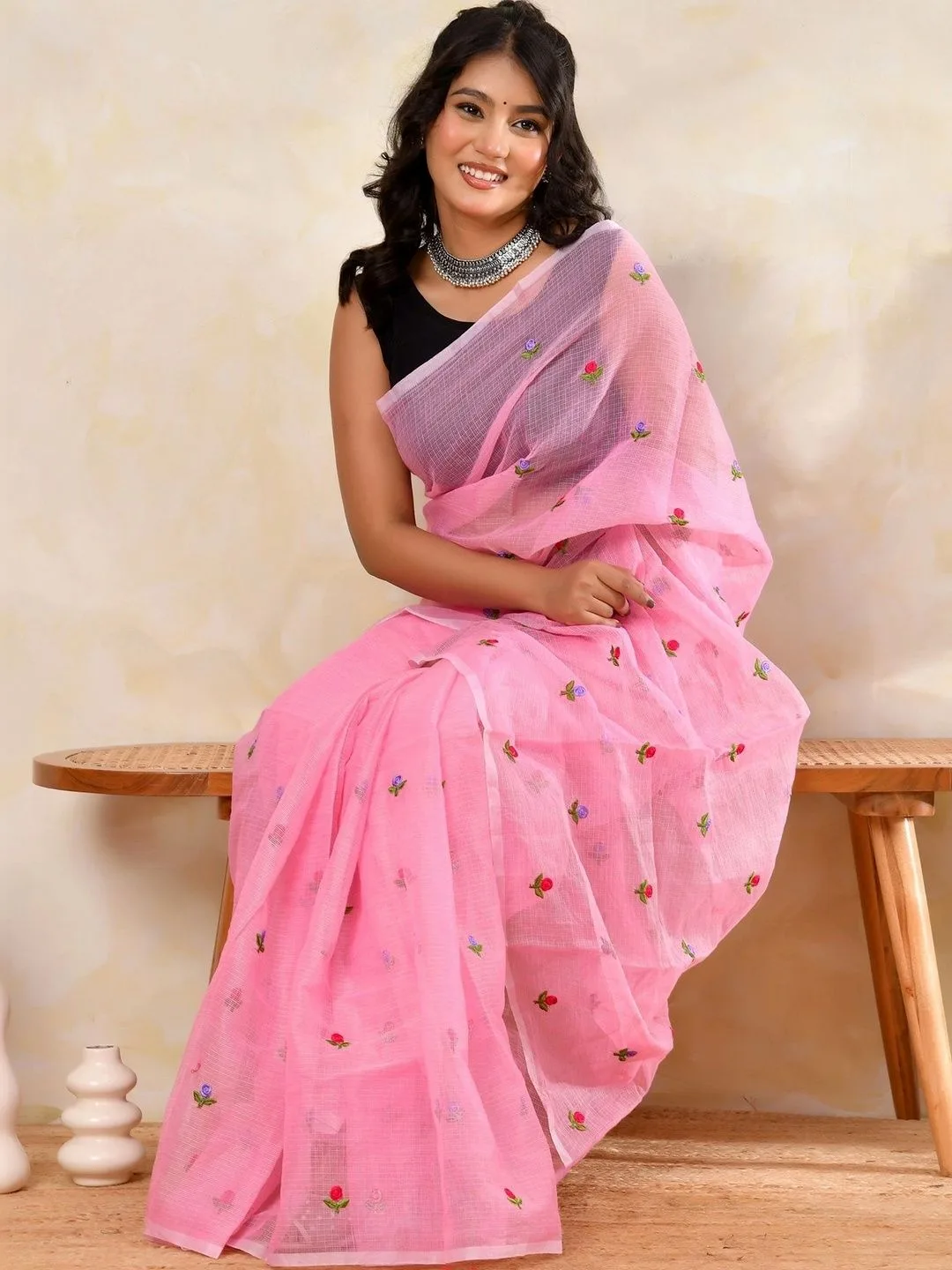 Pink Kota Doria floral embroidered saree — seated side view