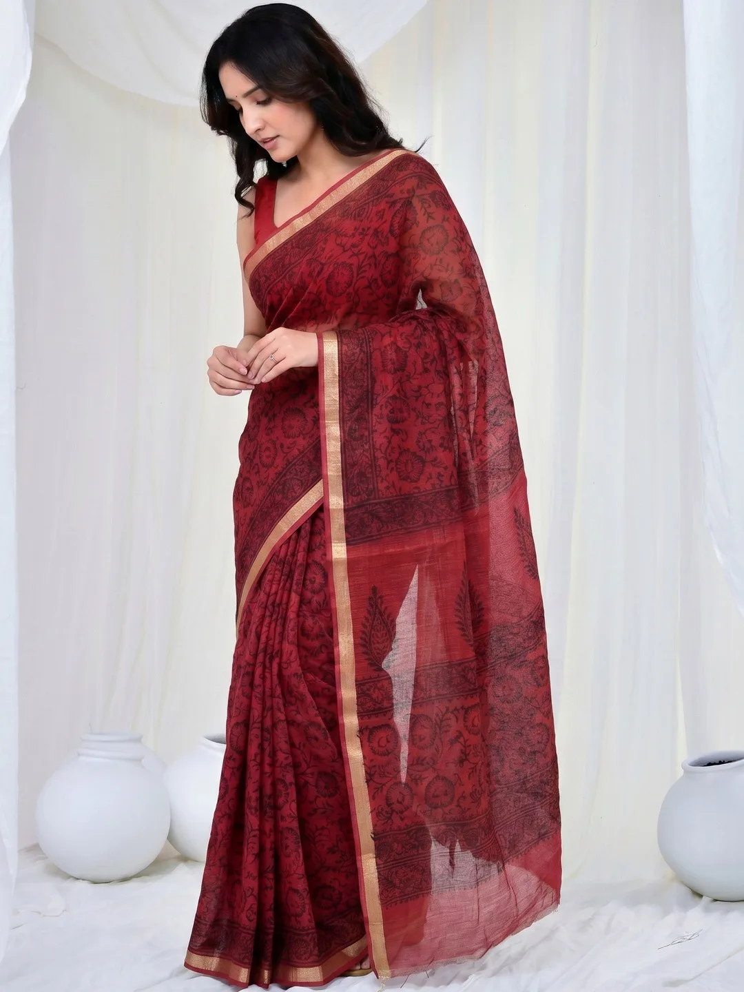 Printed ethnic motifs and zari border on red Kota Doria — detail